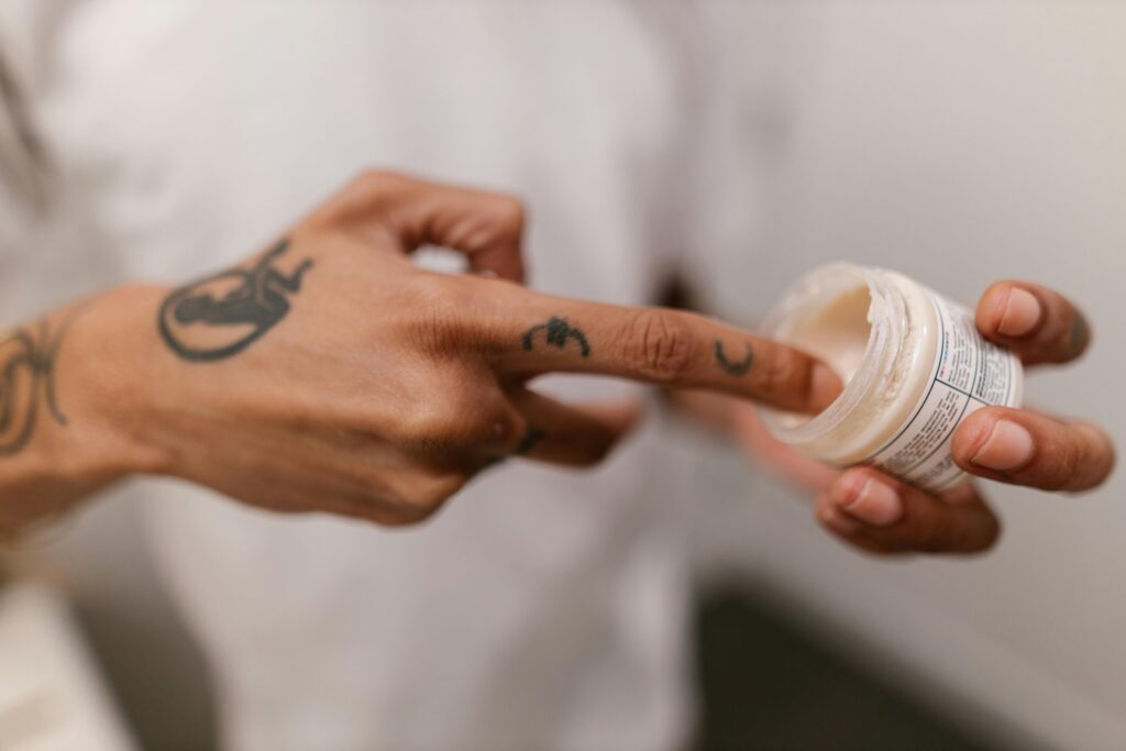 Person applying ZO Skin Health cream to their skin, highlighting the effectiveness of skincare products based on the latest science.